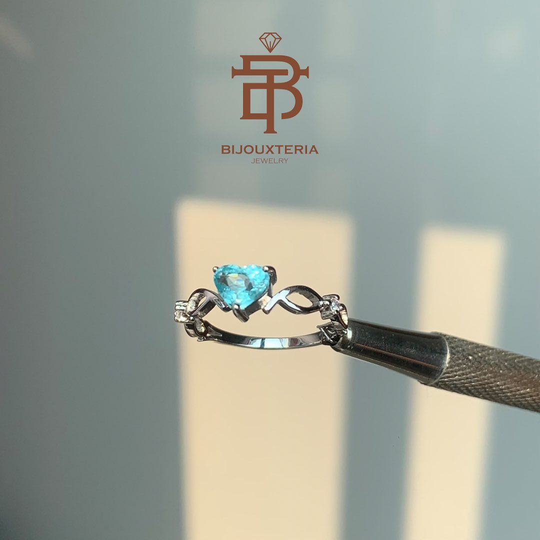 Elegant Slender Shank Ring Featuring Heart Brilliant Cut Teal Blue Gemstone and Infinity Accents